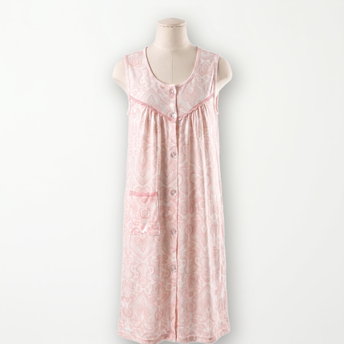 Bata clasica Camelia, crema con paisley rosa, sin mangas y abotonada entera, vista completa